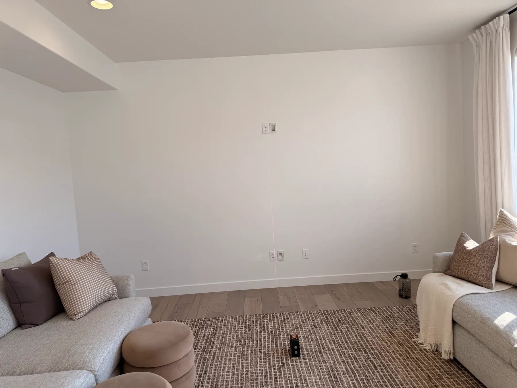 Living room with a blank wall before the remodel by BK Toolbox