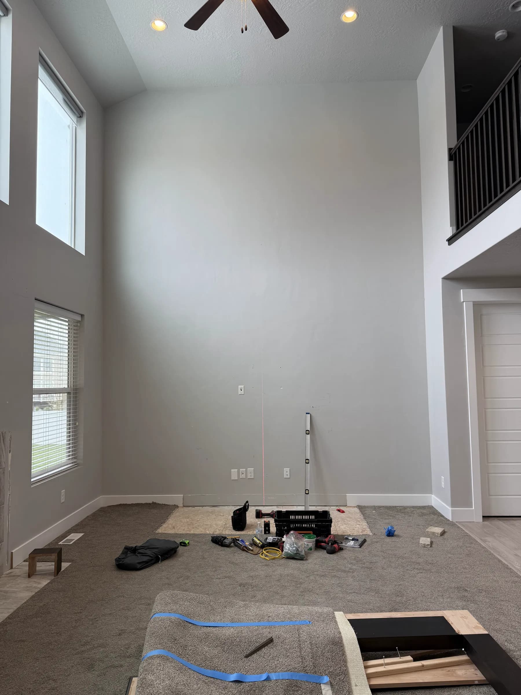 Two-story great room before the remodel, bare wall by BK Toolbox