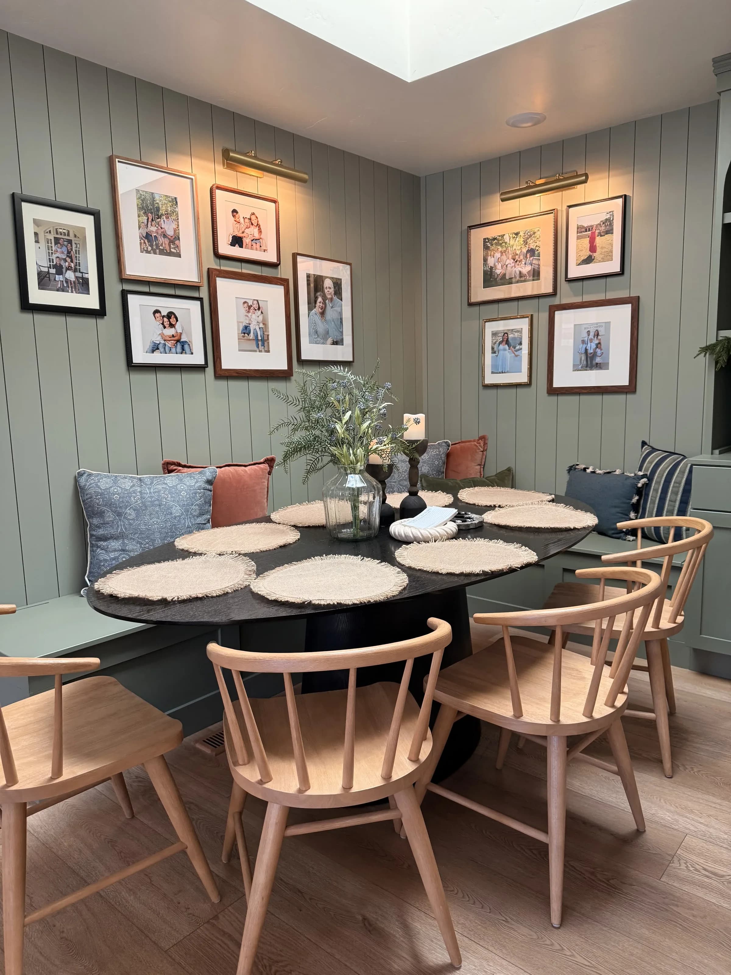 Dining nook with sage green shiplap walls and custom bench seating by BK Toolbox