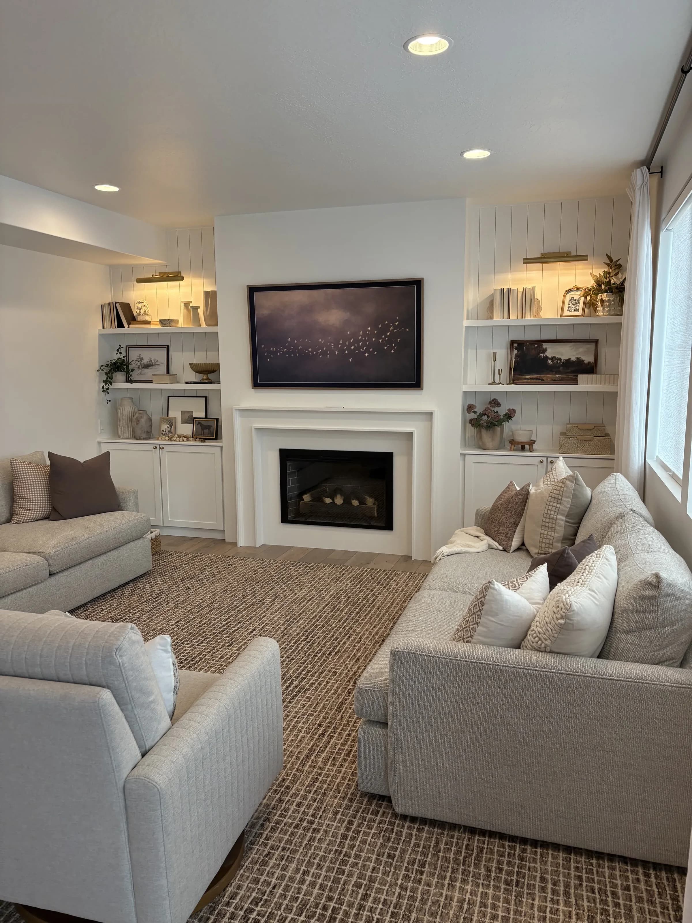 Living room with custom fireplace built-ins and shiplap walls by BK Toolbox Interior Design
