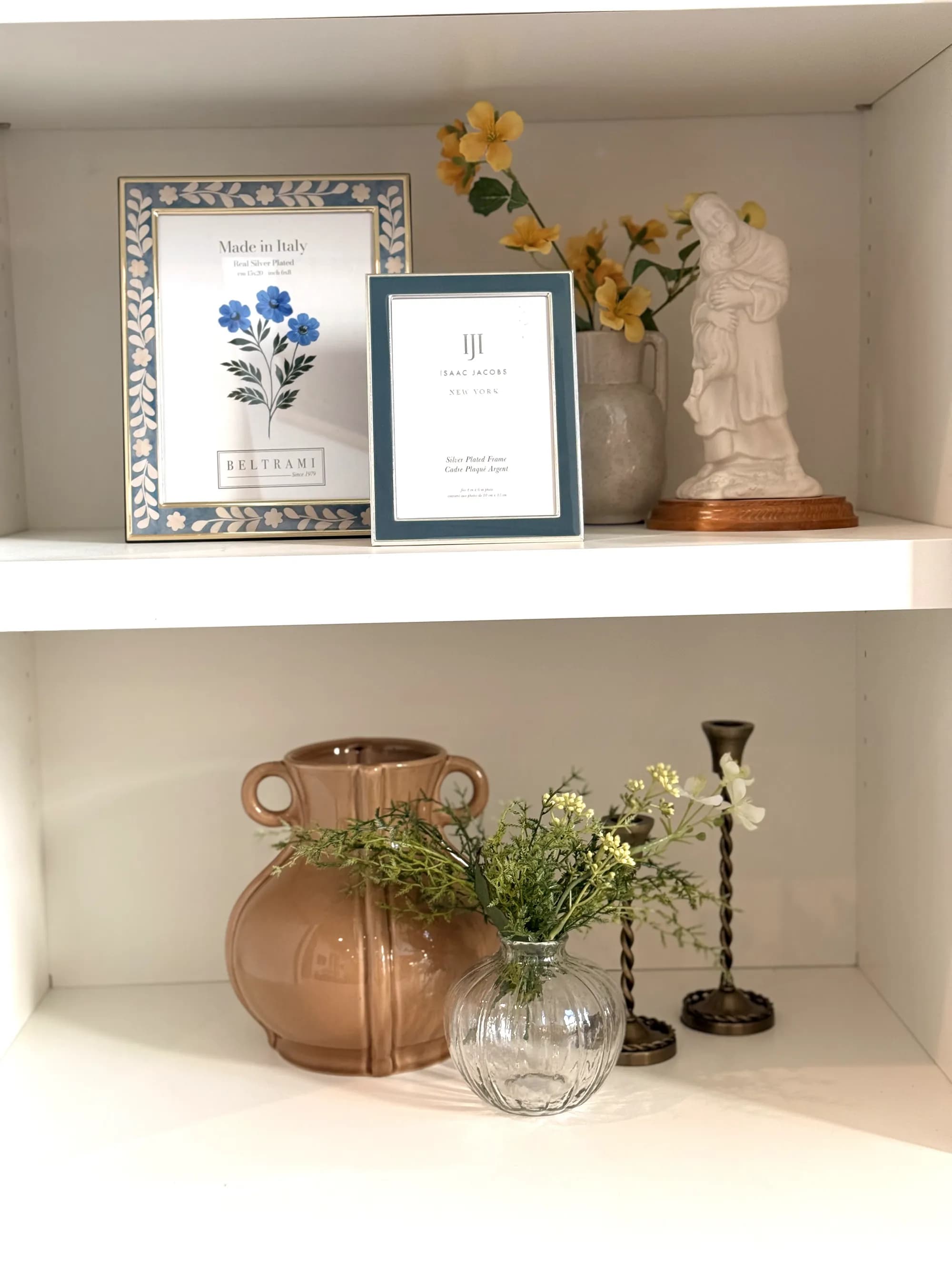 Styled shelf vignette with framed art, figurine, and ceramics by BK Toolbox