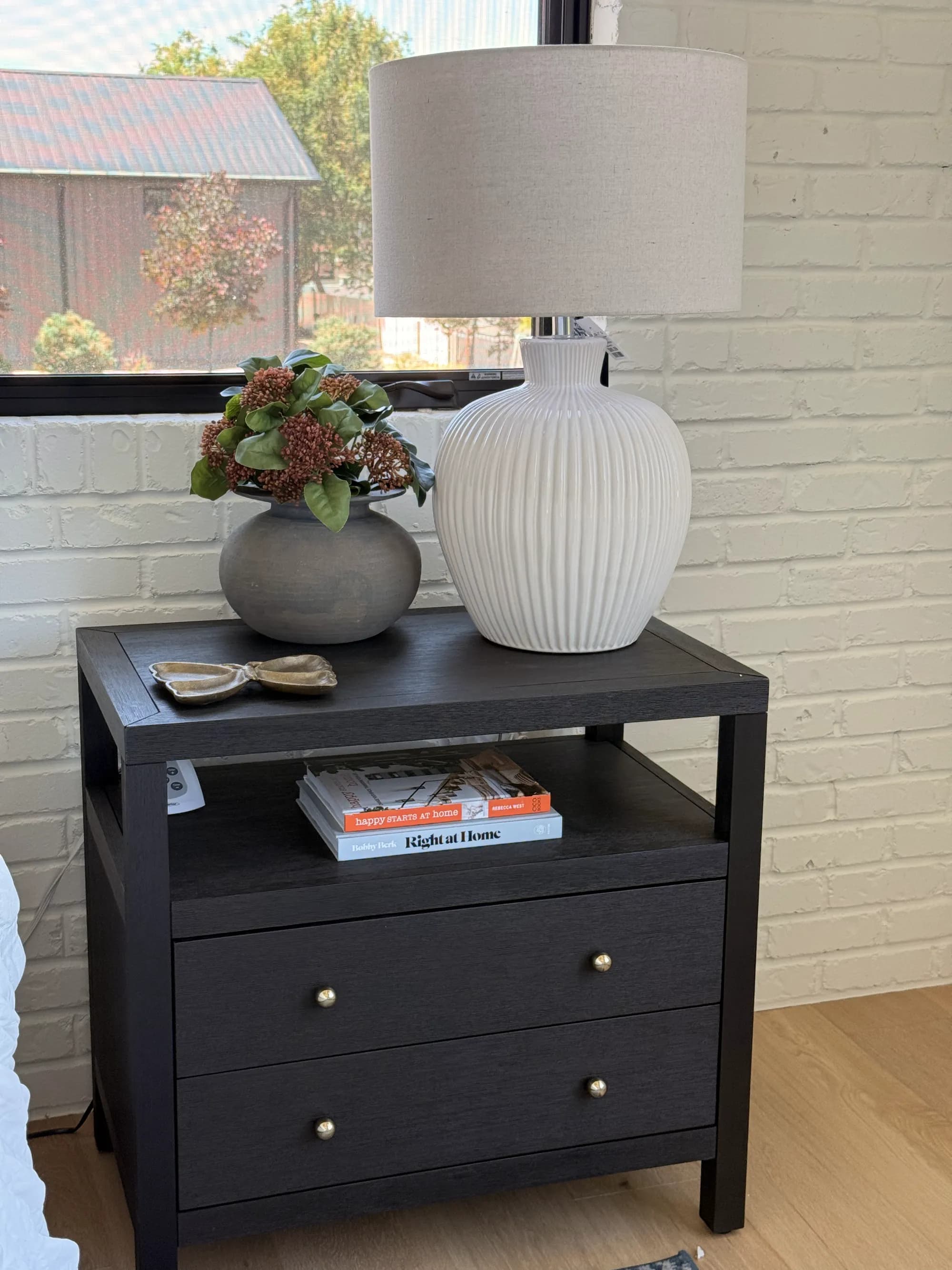 Bedroom nightstand styled with a ribbed lamp and florals by BK Toolbox