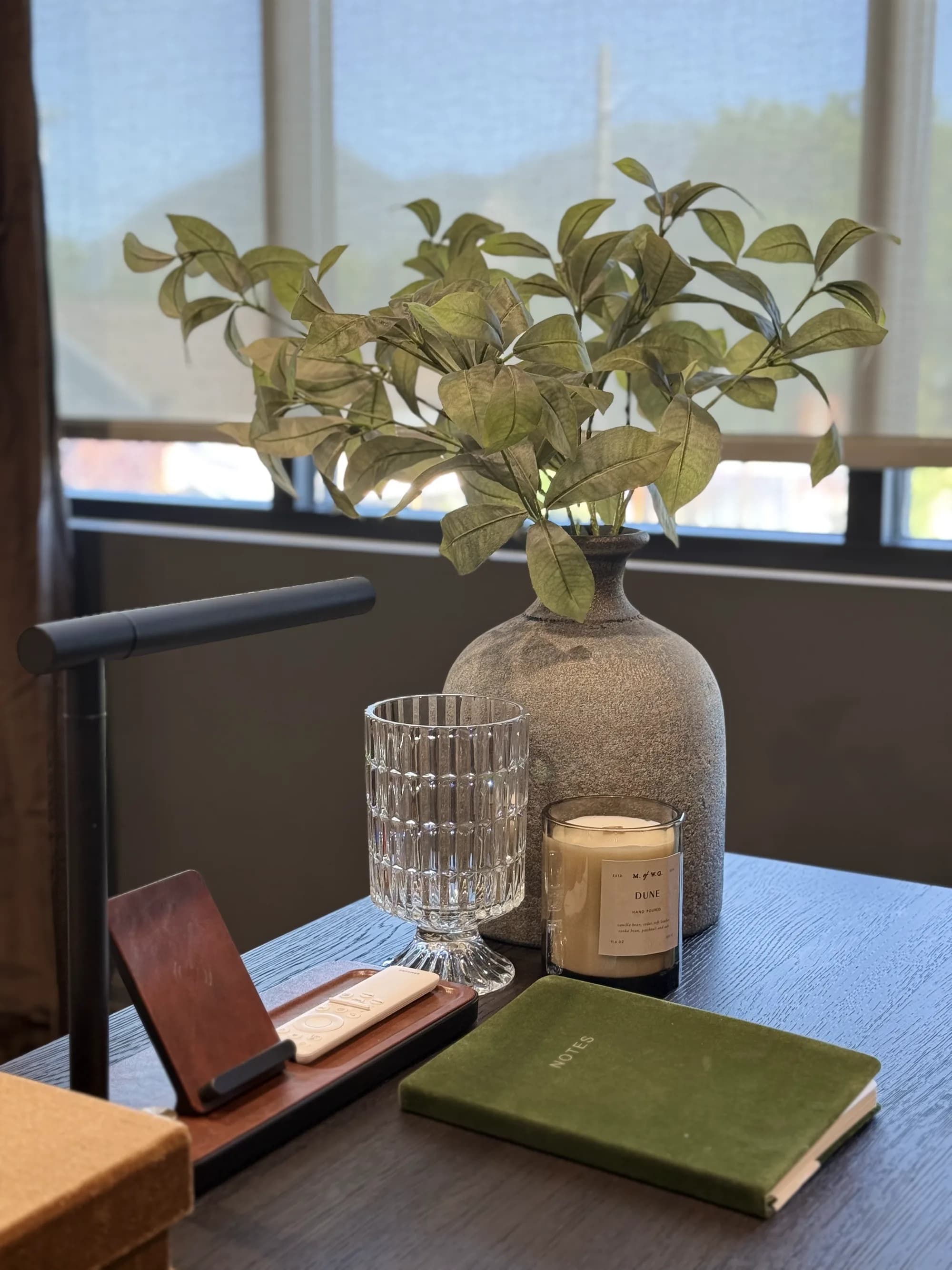 Home office desk styled with a task lamp, ceramic vase, and notebook by BK Toolbox