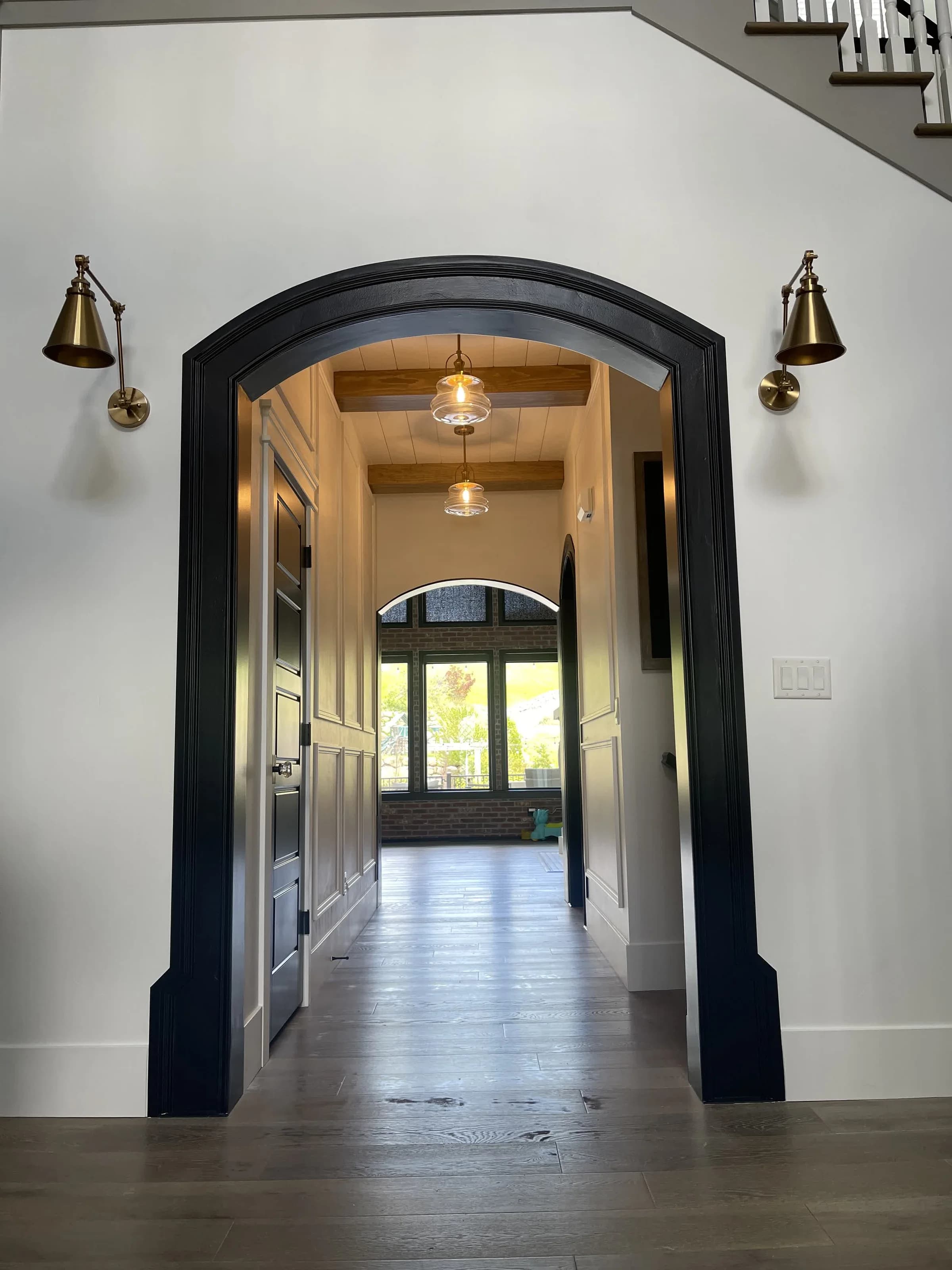 Custom black arched doorway and trim work by BK Toolbox
