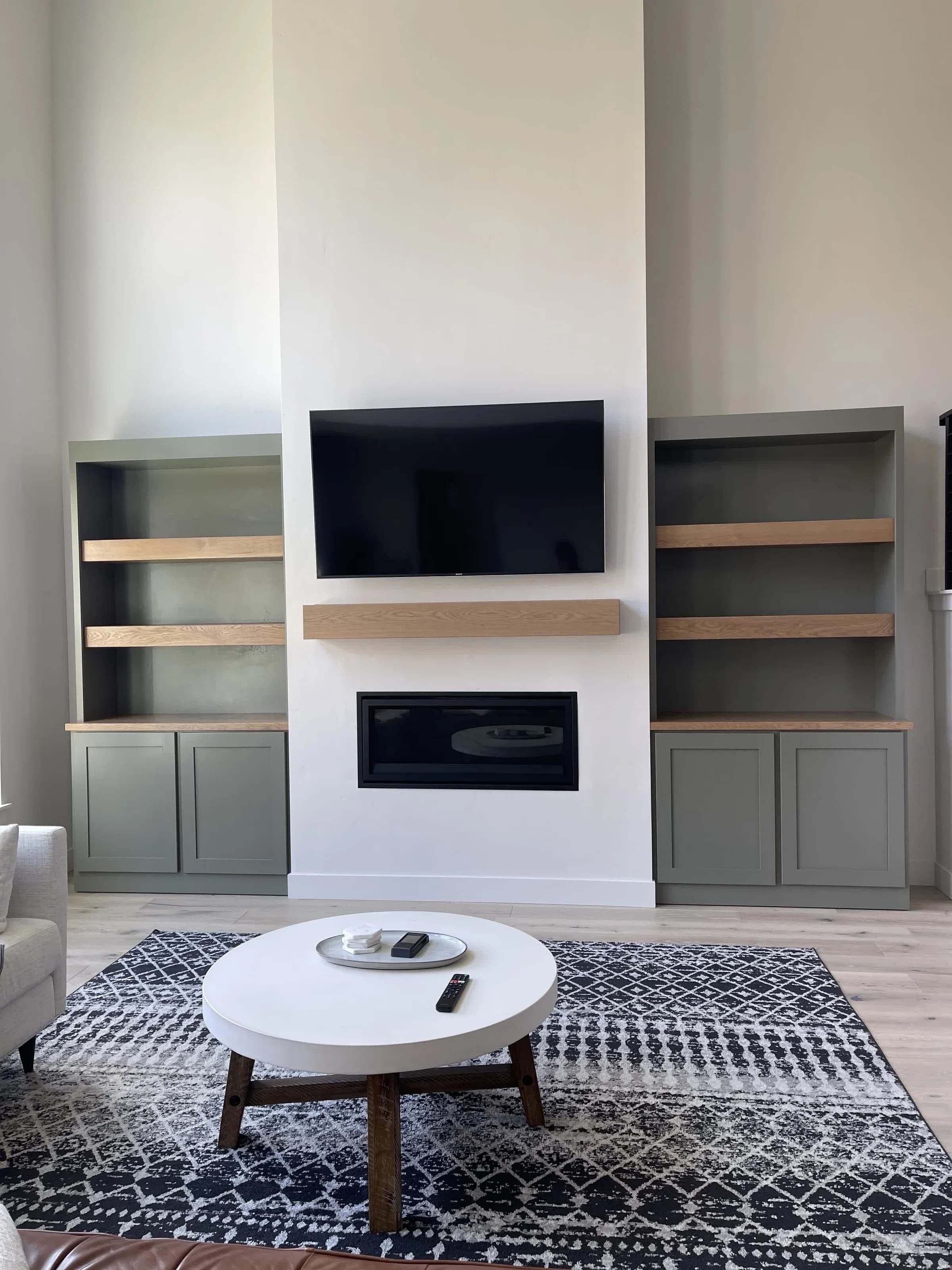 Built-in fireplace cabinetry with sage green cabinets by BK Toolbox