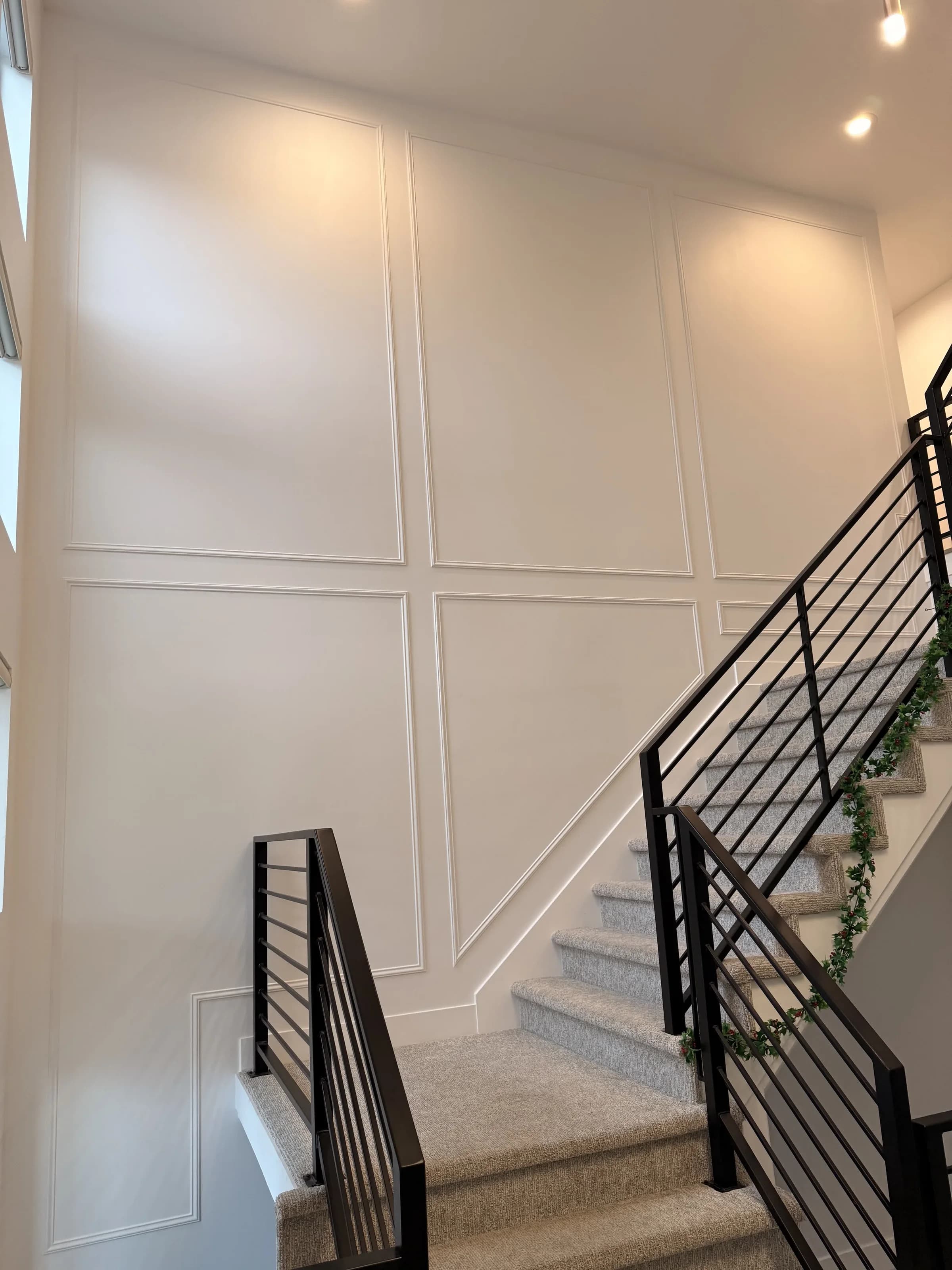 Custom panel molding on staircase wall by BK Toolbox